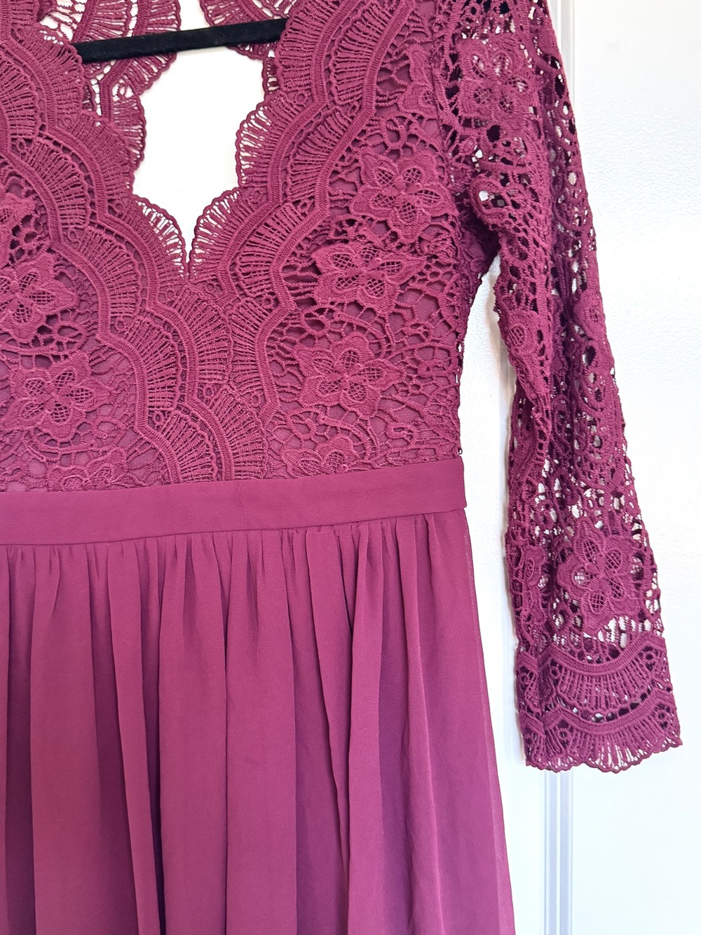 Burgundy maxi bridesmaids dress with lace sleeves, open back, and v neck.